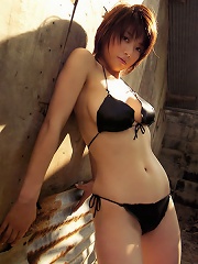 Busty asian babe is erotically beautiful in her printed bikini